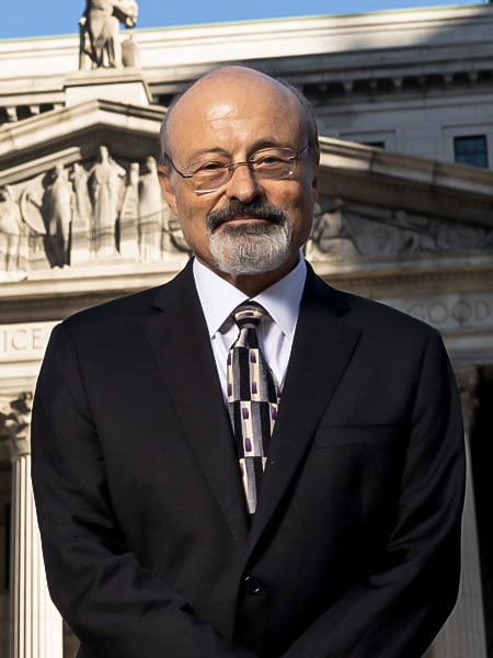 Edward-Rimland-Profile Edward Rimland construction accident attorney, standing in front of of New York City court.